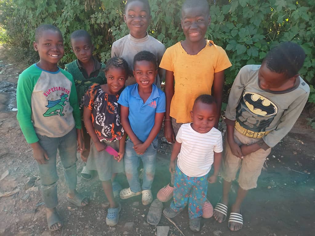 A group of children in a Zambian community, smiling together