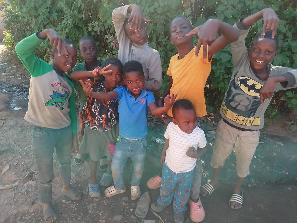 A group of children in Zambia smiling and posing together